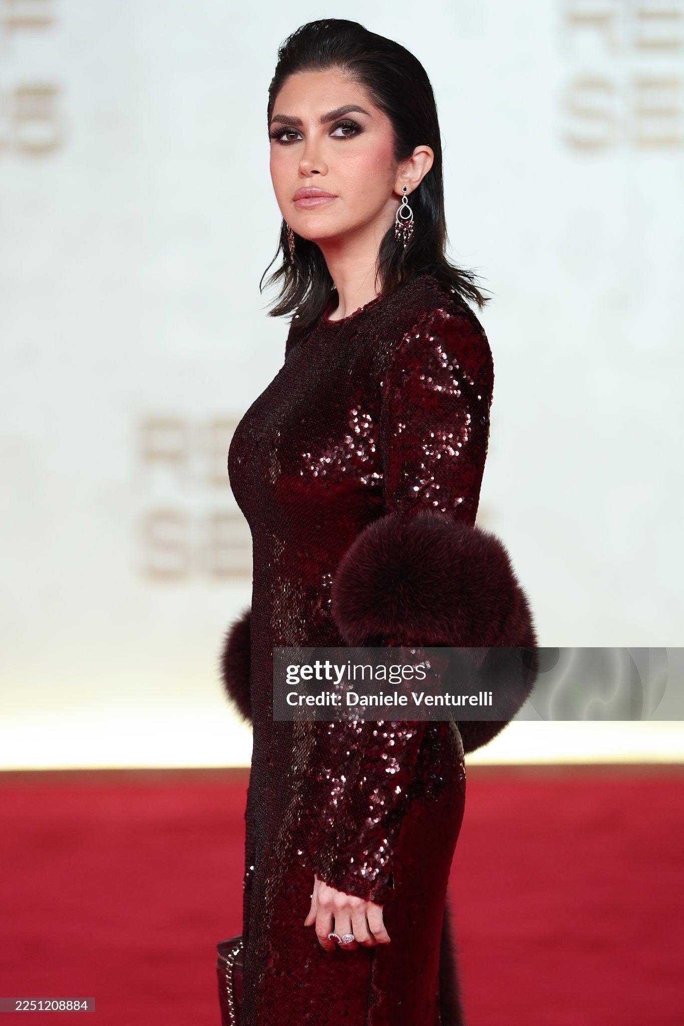 Burgundy sequin gown with fur cape