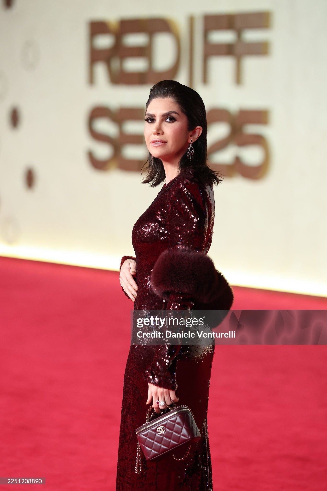 Burgundy sequin gown with fur cape