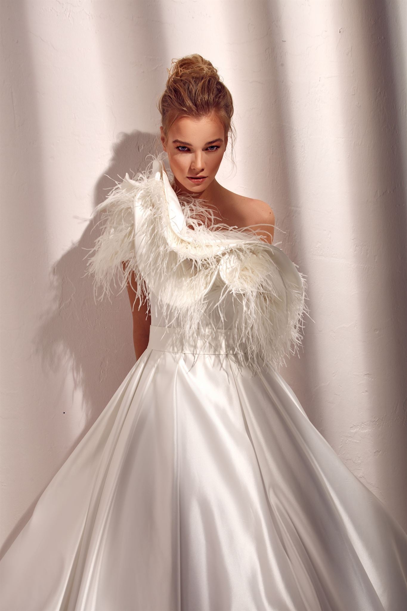 One-shoulder feathered satin A-line gown