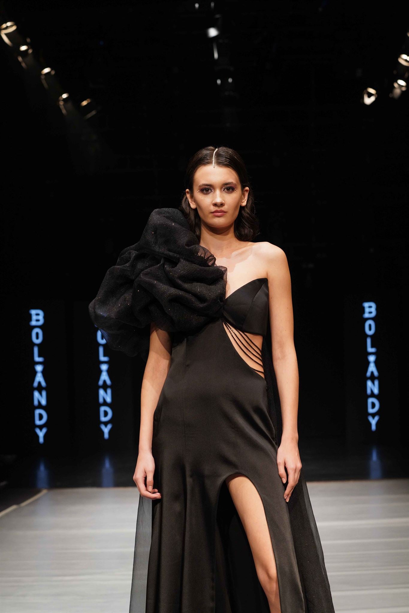 Black one-shoulder ruffle slit gown